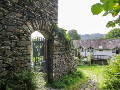 An archway with a gate leading to buildings at Flat 4 Grasmere Lodge in Ambleside