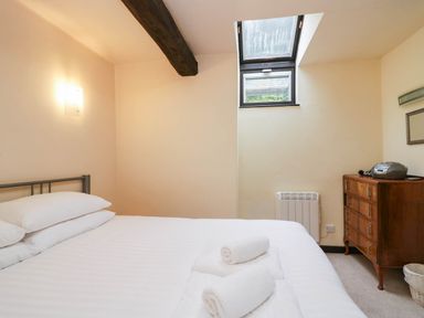 A bedroom with a bed and a dresser at Dunmail Raise, Grasmere Lodge, Grasmere
