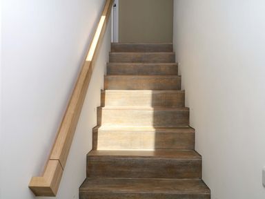 A staircase with wooden steps and a handrail at Reddaway Byre Okehampton