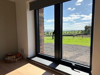 A window with a view and a basket of snacks at High View Barn Launceston