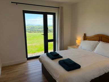 A bedroom with a bed and a view at High View Barn in Launceston