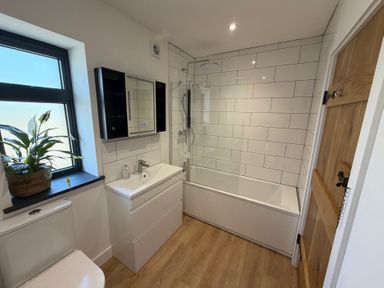 A bathroom with a toilet and bathtub at High View Barn in Launceston