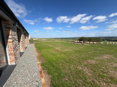 An outdoor area with a pathway and cattle at High View Barn in Launceston
