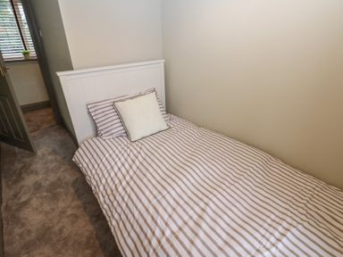 A bedroom with a single bed and a pillow at Corner House in Wark