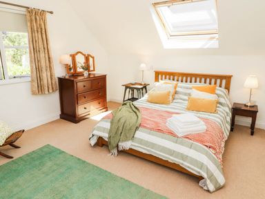 A bedroom with a bed and dresser at 11b Market Street in Narberth