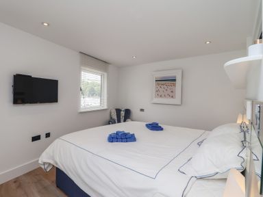 A bedroom with a bed and a television at 5 Sails in Dartmouth
