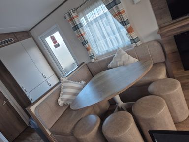 A dining area with a table and seating at Unity Beach in Burnham-on-Sea