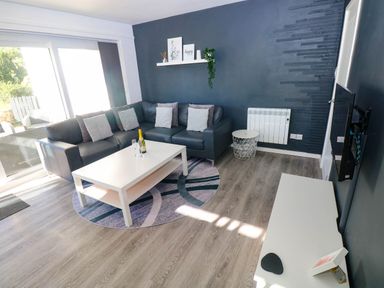 A living room with a sectional sofa and coffee table at Coedrath Park