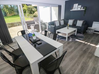 A living room with a sofa, dining table, and coffee table at Coedrath Park