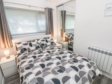 A bedroom with a bed and bedside table at Coedrath Park