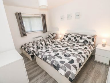 A bedroom with two beds and bedside tables at Coedrath Park