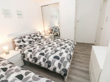 A bedroom with a bed and nightstand at Coedrath Park