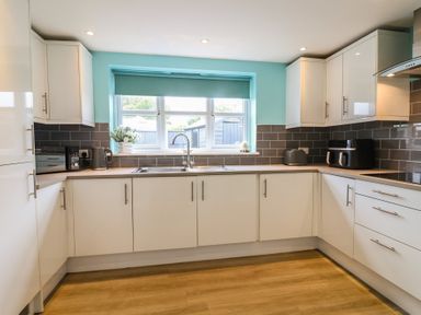 A kitchen with a sink and appliances at Frome View in Wool