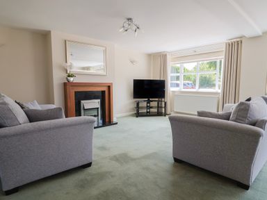A living room with sofas and a television at Frome View in Wool