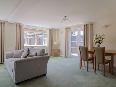 A living room with a sofa, table, and chairs at Frome View in Wool