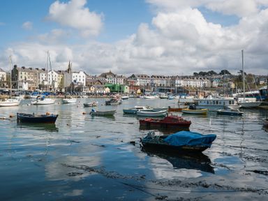 A harbor with boats and buildings at Scoops’ Nook in Caernarfon