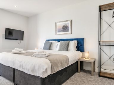 A bedroom with a bed and television at Cotswolds Apartment, sleeps 4 in Chipping Norton