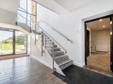 An entrance hall with a staircase and door at Cotswolds Apartment, sleeps 4 in Chipping Norton