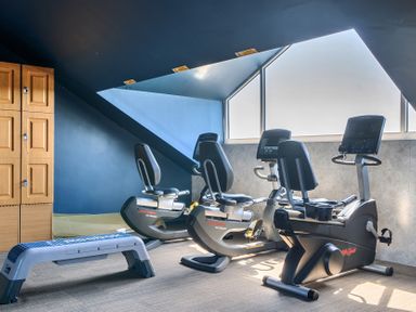 A gym with exercise bikes and a bench at Cotswolds Apartment, sleeps 4 Chipping Norton