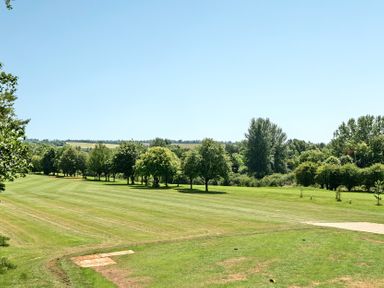 A grassy area with trees in the background at Cotswolds Apartment, sleeps 4, Chipping Norton