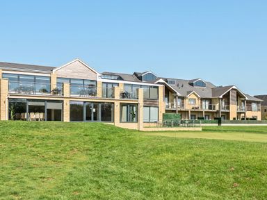 A building with balconies and large windows at Cotswolds Apartment, sleeps 4 in Chipping Norton
