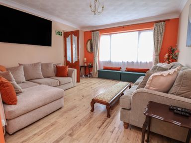 A living room with a sofa and coffee table at Hafan Deg in Holywell