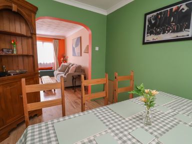 A dining room with a table and chairs at Hafan Deg in Holywell