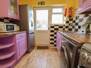 A kitchen with a refrigerator and microwave at Hafan Deg in Holywell