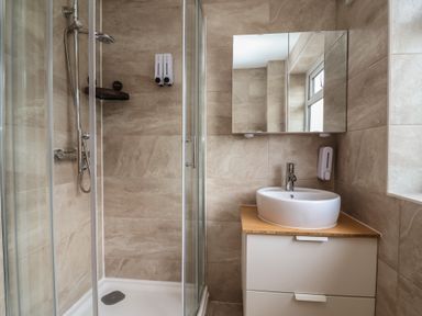 A bathroom with a shower and sink at Hafan Deg in Holywell