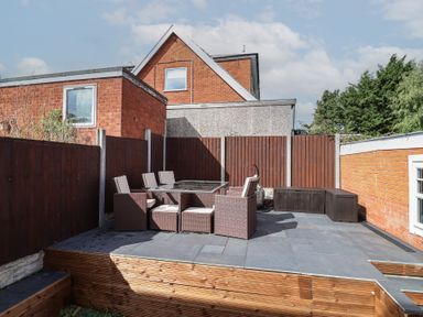 A garden with seating and a table at Hafan Deg in Holywell