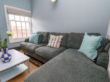 A snug with a sofa and coffee table at Apartment Blue in Whitby
