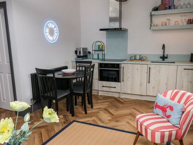 A kitchen with table and chairs at Apartment Blue in Whitby