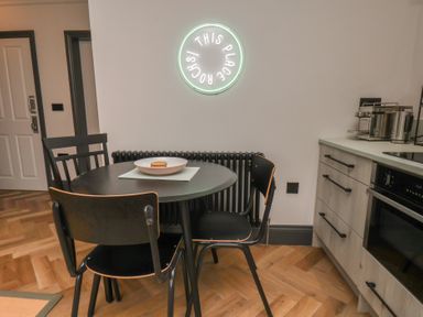 A kitchen with a table and chairs at Apartment Green in Whitby