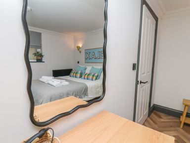A bedroom with a bed and decorative pillows at Apartment Yellow in Whitby