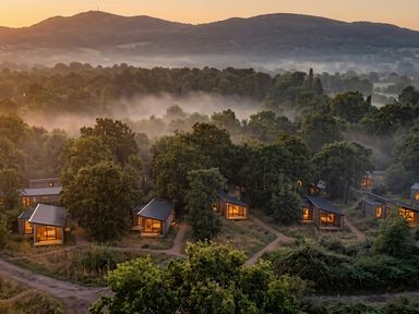 View of cabins surrounded by trees and mountains at Arbora 1.0 Spa (Pet) Malvern