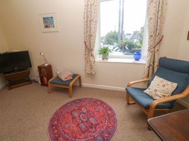 A living room with a television and an armchair at Chyancrowse in Gulval