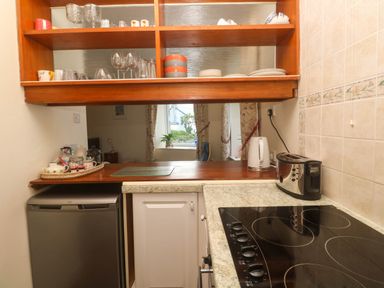 A kitchen with shelves and appliances at Chyancrowse in Gulval