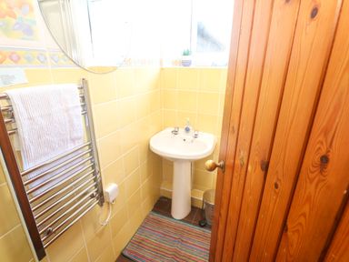 A bathroom with a sink, towel rack, and mirror at Chyancrowse in Gulval