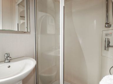 A bathroom with a sink and shower at Roslenn in St Agnes