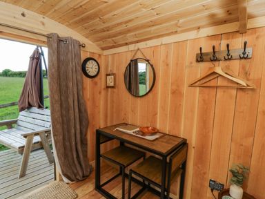 An indoor photo of a room with a wooden table and chairs at The Little Shepherds Hut with a View in Builth Wells