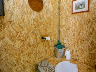 A bathroom with a toilet and mirror at The Little Shepherds Hut with a View Builth Wells