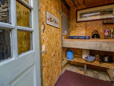 A kitchen with shelves and kitchen equipment at The Little Shepherds Hut with a View in Builth Wells