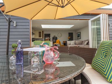 An outdoor seating area with a table and chairs at Trefin Cemaes Bay