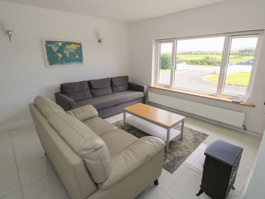 A living room with sofas and a table at Tí Chonaill