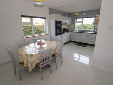 A kitchen with a dining table and chairs at Tí Chonaill in 
