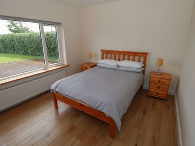 A bedroom with a bed and bedside tables at Tí Chonaill in 