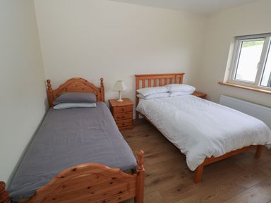 A bedroom with a single bed and a double bed at Tí Chonaill in 
