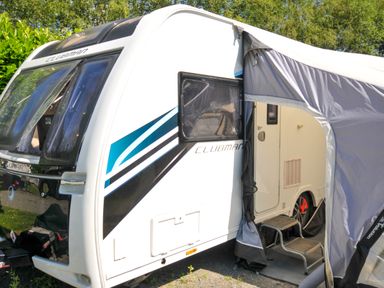 A caravan with an awning and steps at Caravan in Dolton