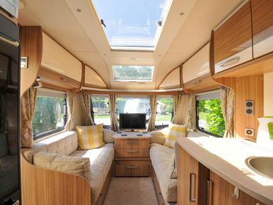 A living room with a couch and television in Caravan Dolton