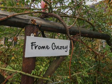 A sign reading Frome Gazey with plants and branches at Frome Gazey Barn in Frampton